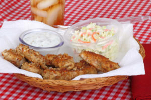 Chicken strips meal with coleslaw and sauce in a basket