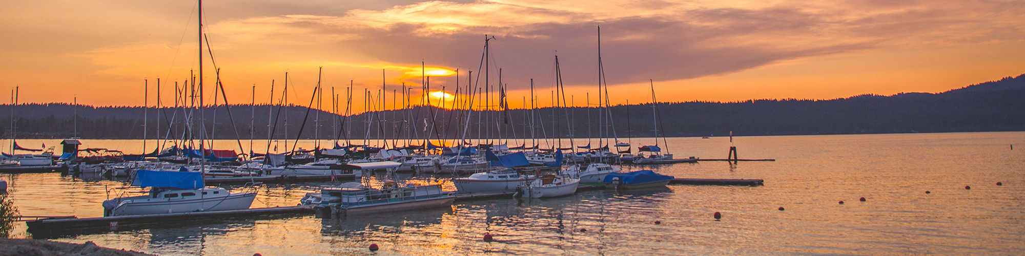 Sunset over Payette Lake in McCall, Idaho at a sailboat marina.