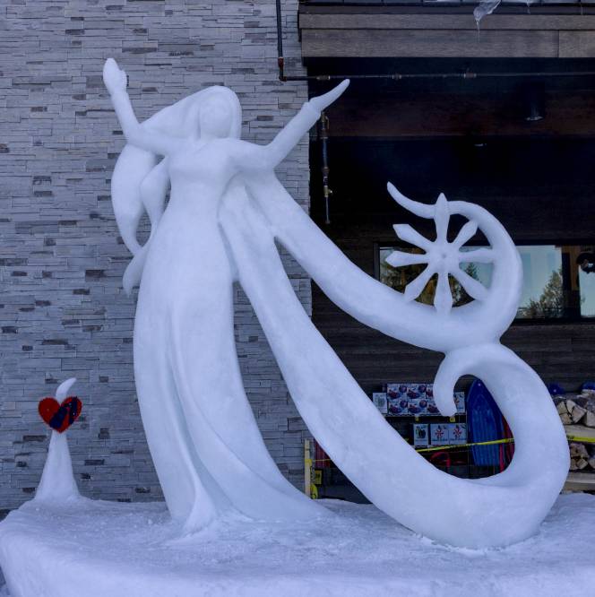 An ice queen sculpted out of ice and snow.
