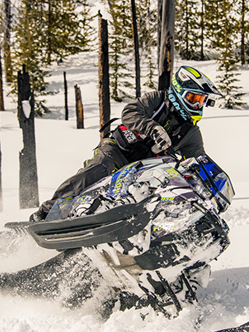 A person makes a turn on a snowmobile.