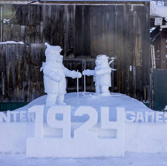 Two skiers sculpted out of ice and snow.