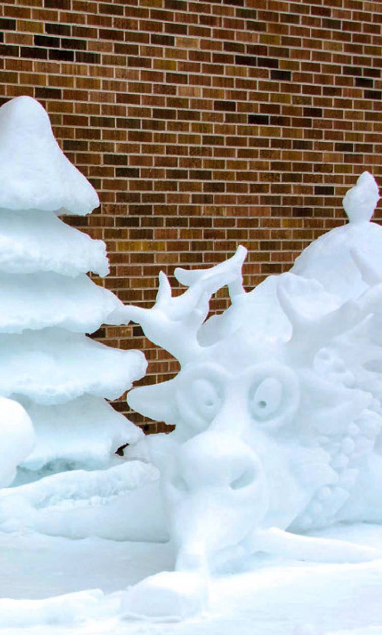 Trees and mythical creatures sculpted out of ice and snow.