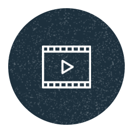 An illustrated icon showing a film reel with a play button at its center.