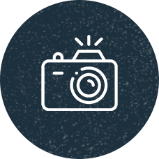 An illustrated icon of a camera.