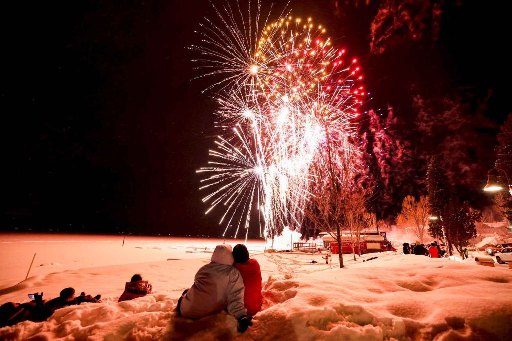 People watch the fireworks overhead during the McCall Winter Carnival in McCall, Idaho.